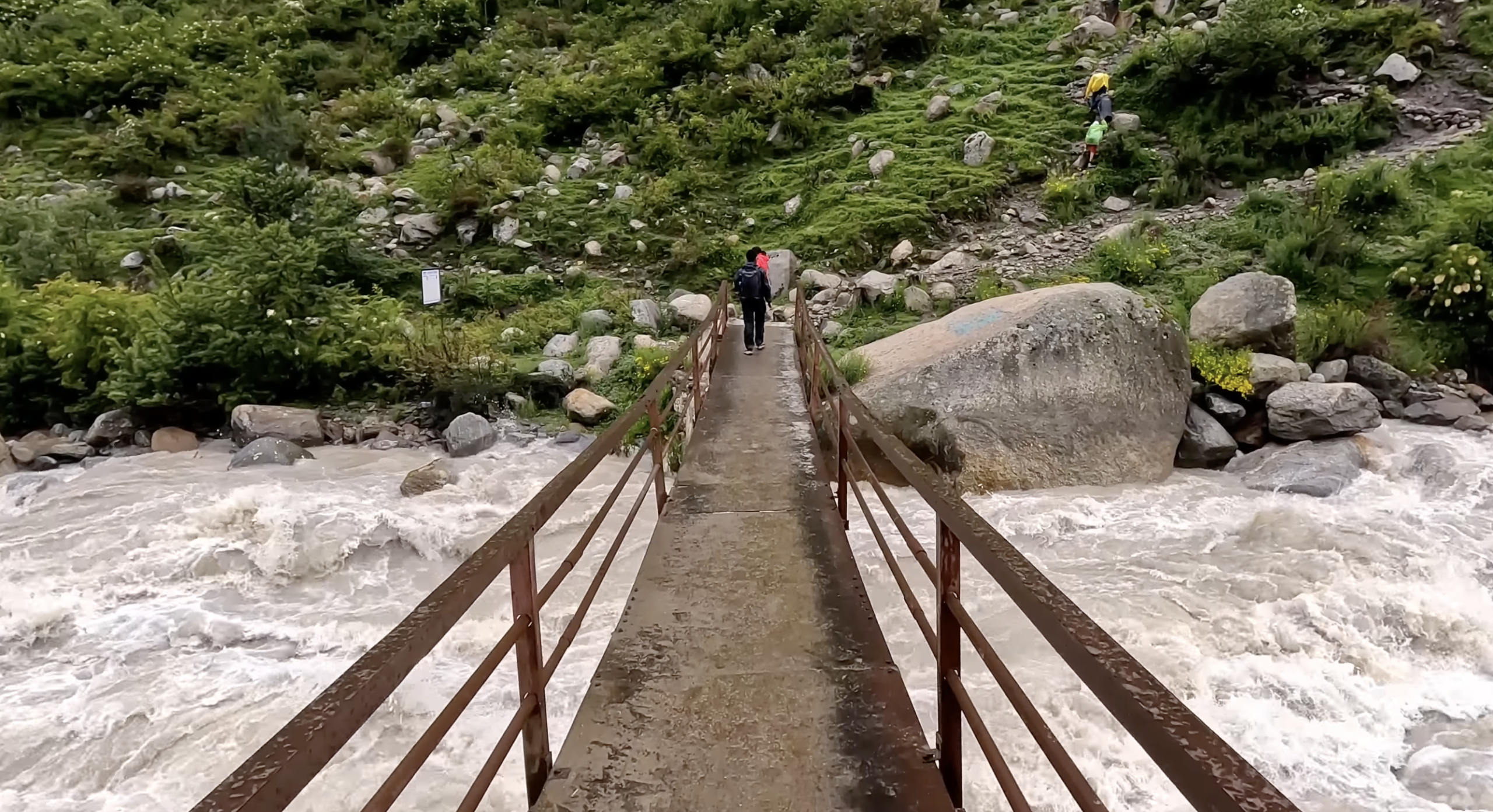 Cross bridges during trek to Kheerganga